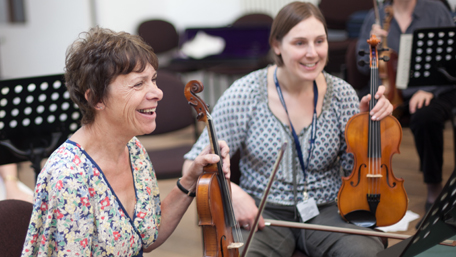 undefinedtwo violinists laughing