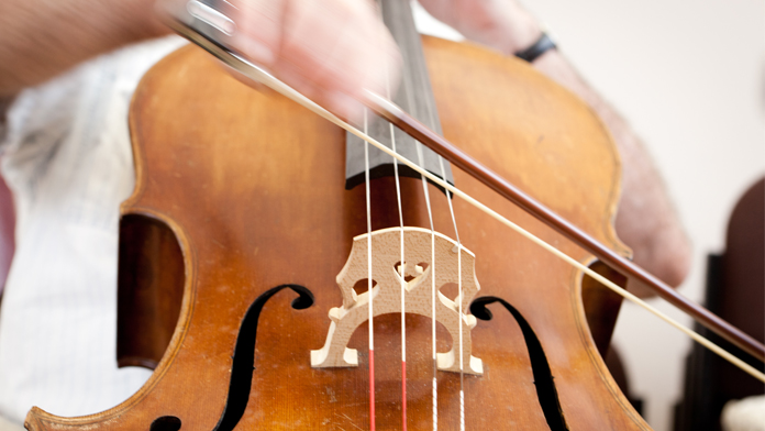 undefinedthe moving hands of a cellist playing on a course at Benslow